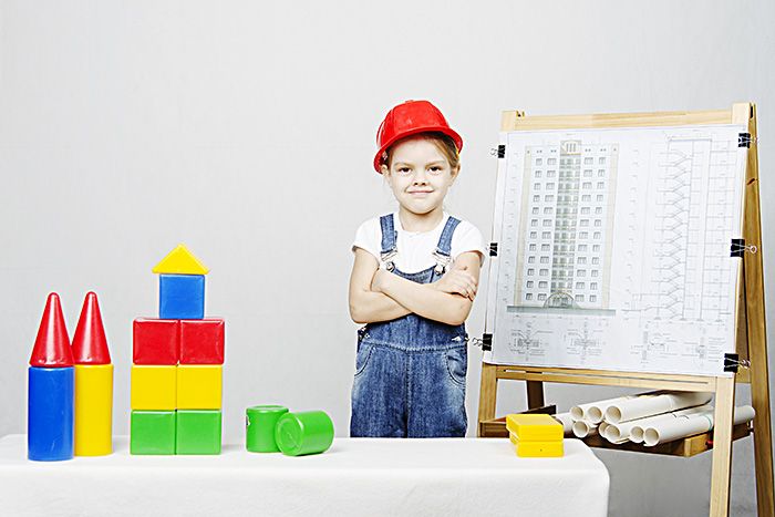 young girls dressed up as a builder